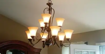 Classic ceiling chandelier installation with warm lighting in St Paul, MN