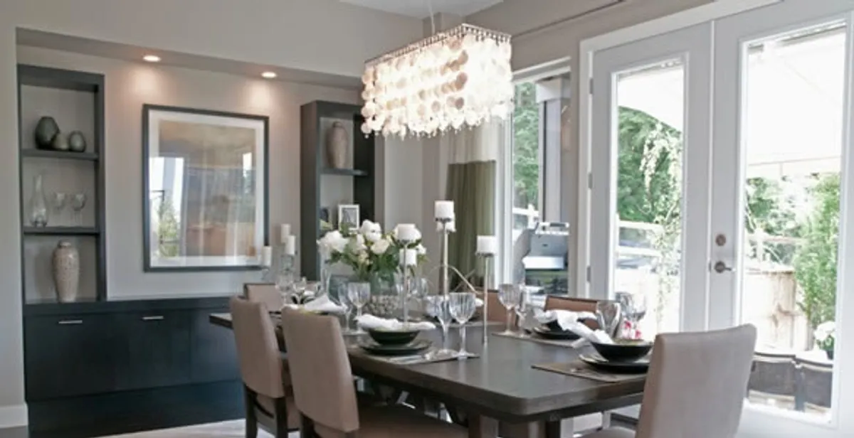 Elegant dining room chandelier installation above table in St Paul, MN