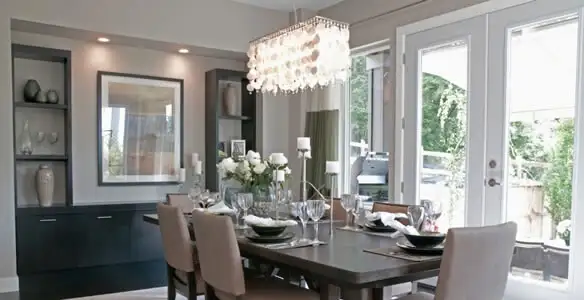 Elegant dining room chandelier installation above table in St Paul, MN
