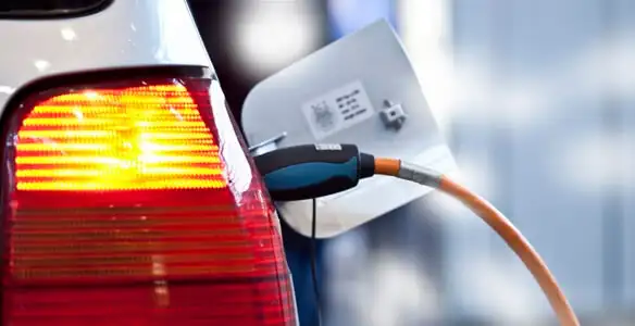 Electric car plugged into EV charger after professional installation in St Paul, MN