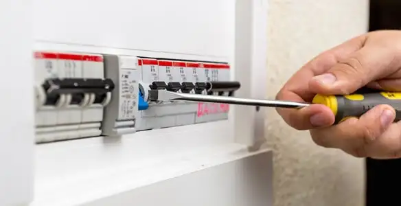 electrical panel upgrade service showing technician adjusting circuit breakers during system upgrade in St Paul, MN