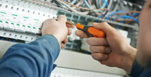 electrical service showing licensed electrician performing electrical panel maintenance and adjustments in St Paul, MN