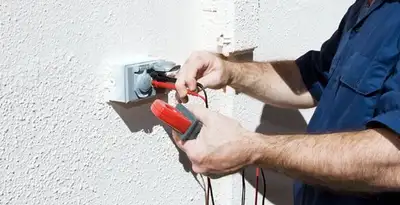 Electrician performing home electrical outlet and wiring inspection in St Paul, MN