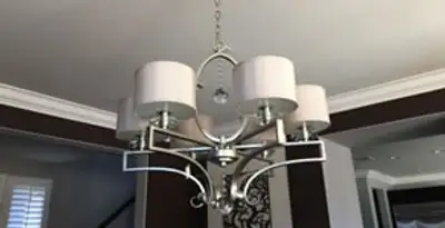 Modern chandelier installation with multiple light fixtures in St Paul, MN