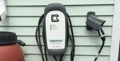 Outdoor electric vehicle charger installation on residential wall in St Paul, MN