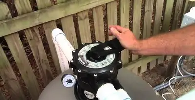 pool pumps service showing professional adjustment of pool pump control system in St Paul, MN