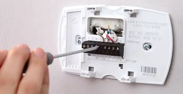 Thermostat installation service with proper wiring and secure wall mounting in St Paul, MN