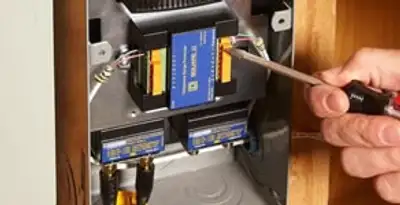 Whole home surge protection device being installed by a licensed electrician to protect electrical systems in St Paul, MN